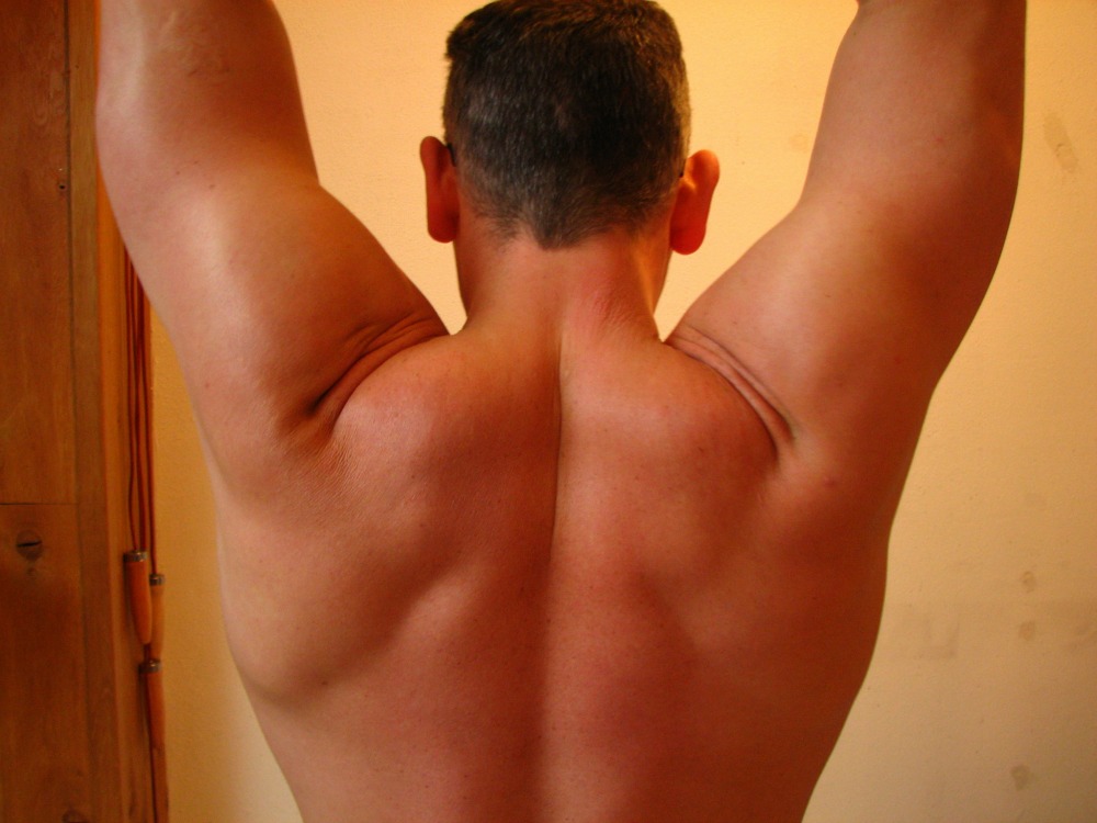 tight neck and back muscles on a man because he's stressed out
